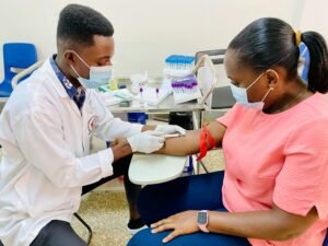 A healthcare worker administers an injection to a patient in a medical clinic.